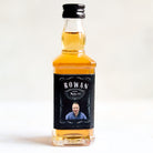 A small bottle with a green cap and a custom label that reads 'Jungle Juice', indicating it's a mocktail or a playful drink name, with a date '2021' and some decorative elements.