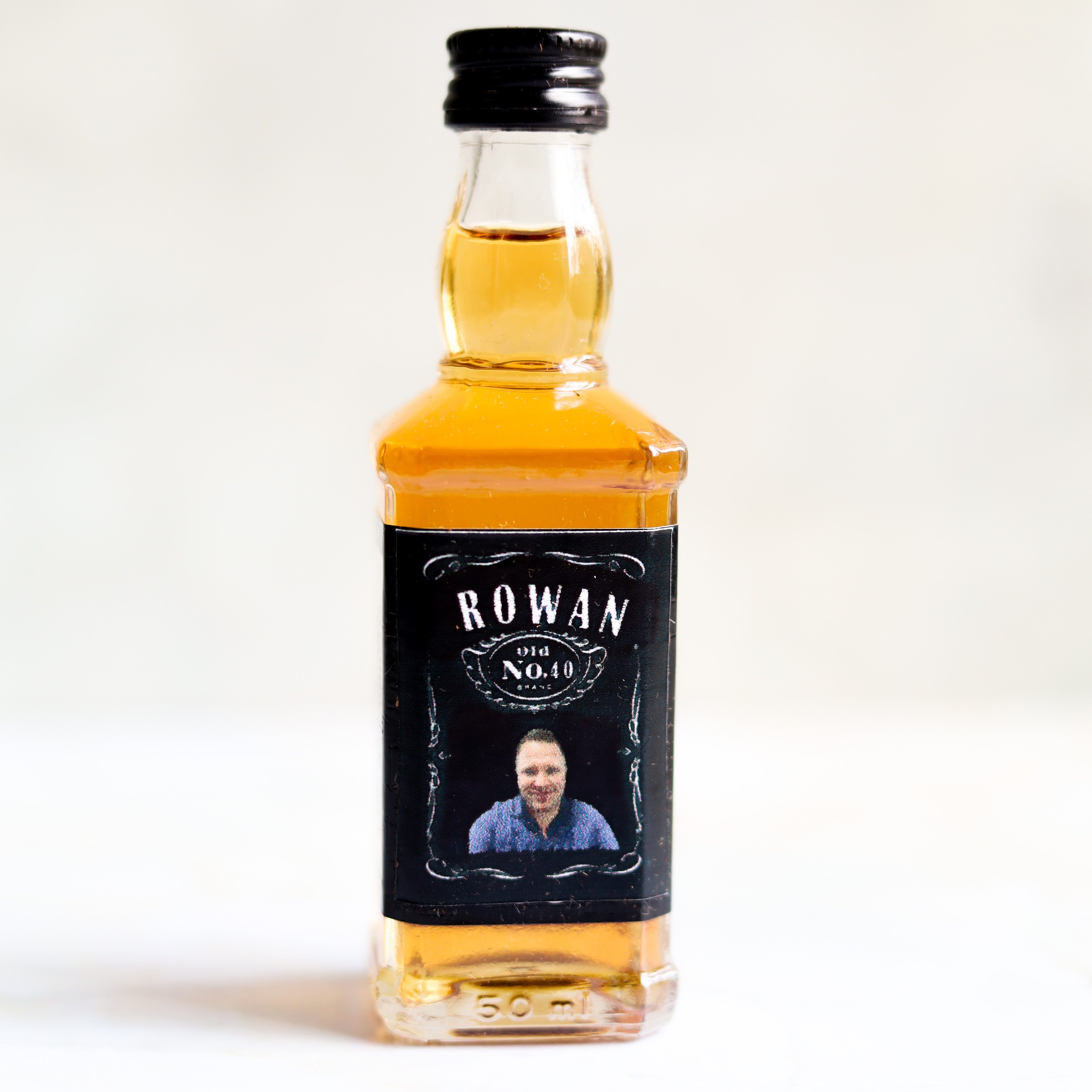 A small bottle with a green cap and a custom label that reads 'Jungle Juice', indicating it's a mocktail or a playful drink name, with a date '2021' and some decorative elements.